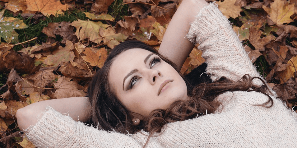 Woman lying on leaves