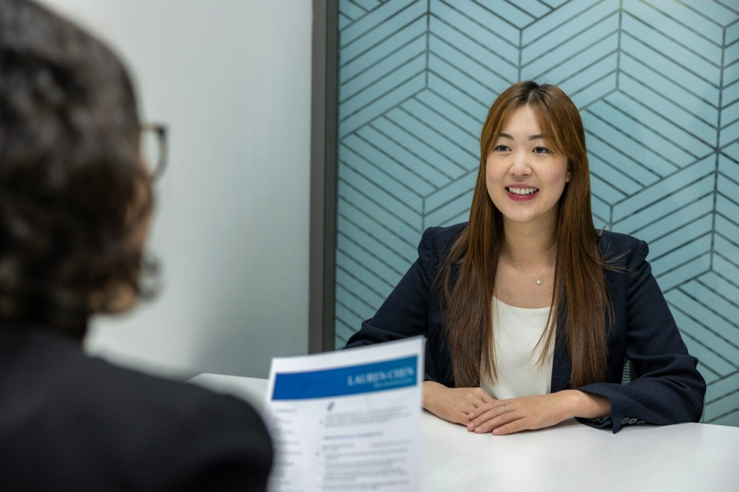 Woman sitted facing interviewer for a job interview