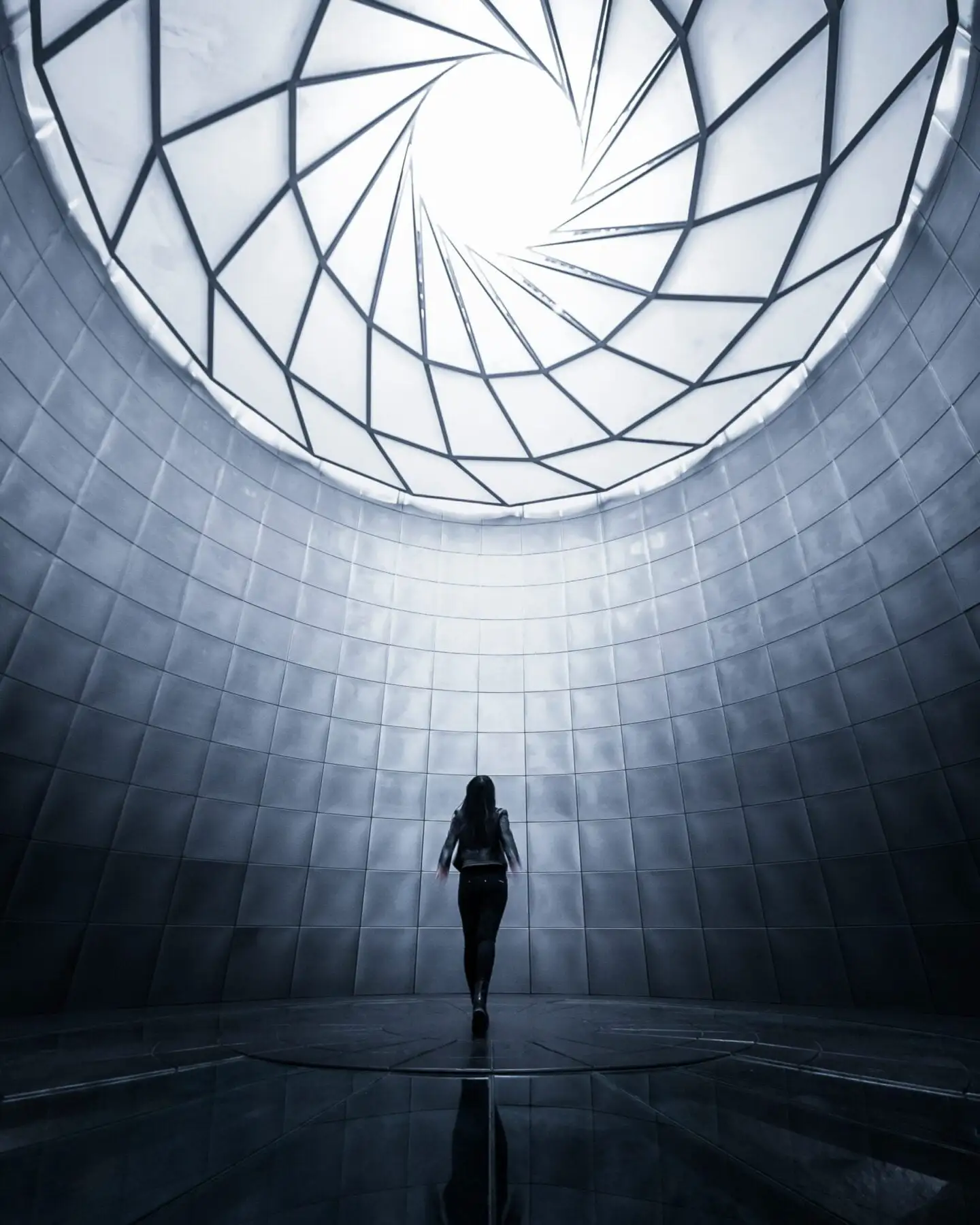 woman walking under a glass ceiling.